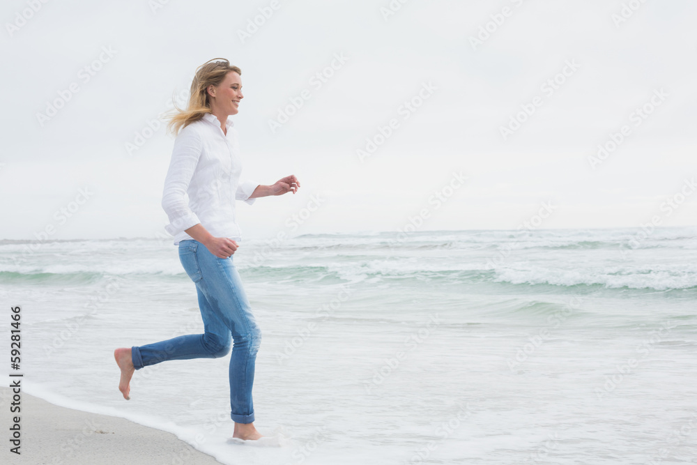 Side view of a woman running at beach