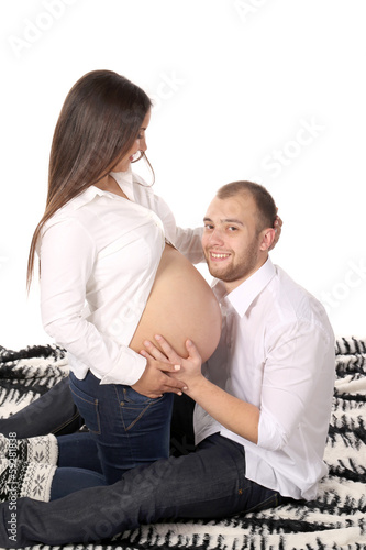 Happy men smiling with pregnant woman.