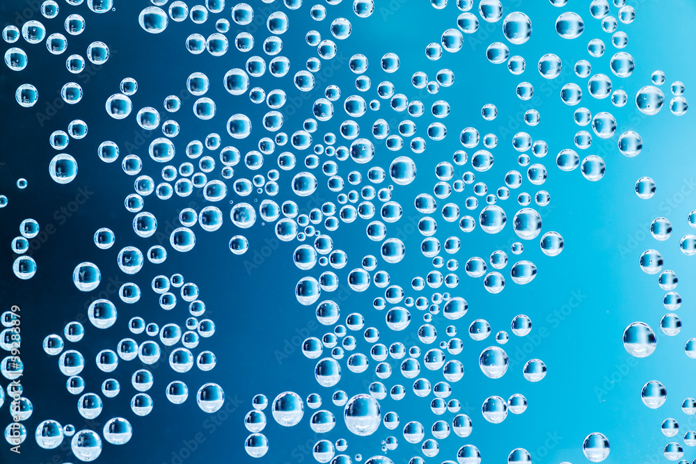Air bubbles in water. Blue background. Macro