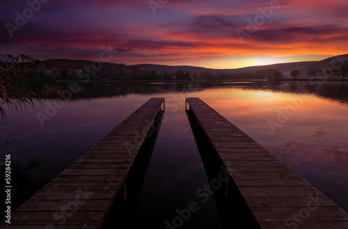 Fototapeta Naklejka Na Ścianę i Meble -  Mystical Landscape, two long pier at dawn