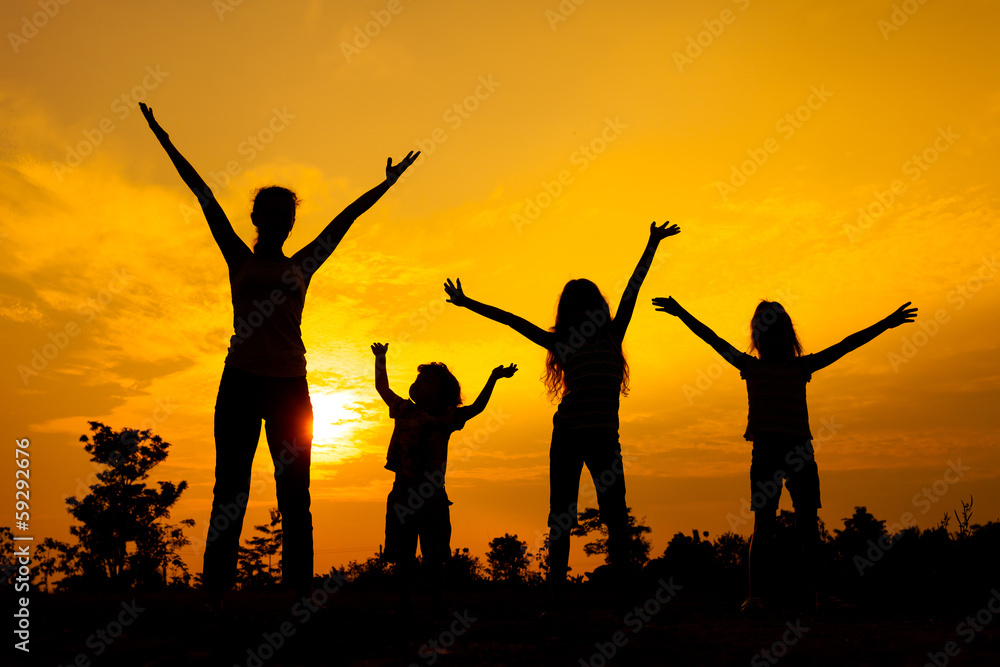 Happy  family standing on the  road in the  sunset time.