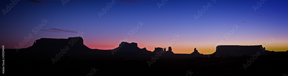 Panoramic photo of Monument Valley at night just before sunrise