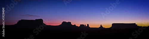 Panoramic photo of Monument Valley at night just before sunrise