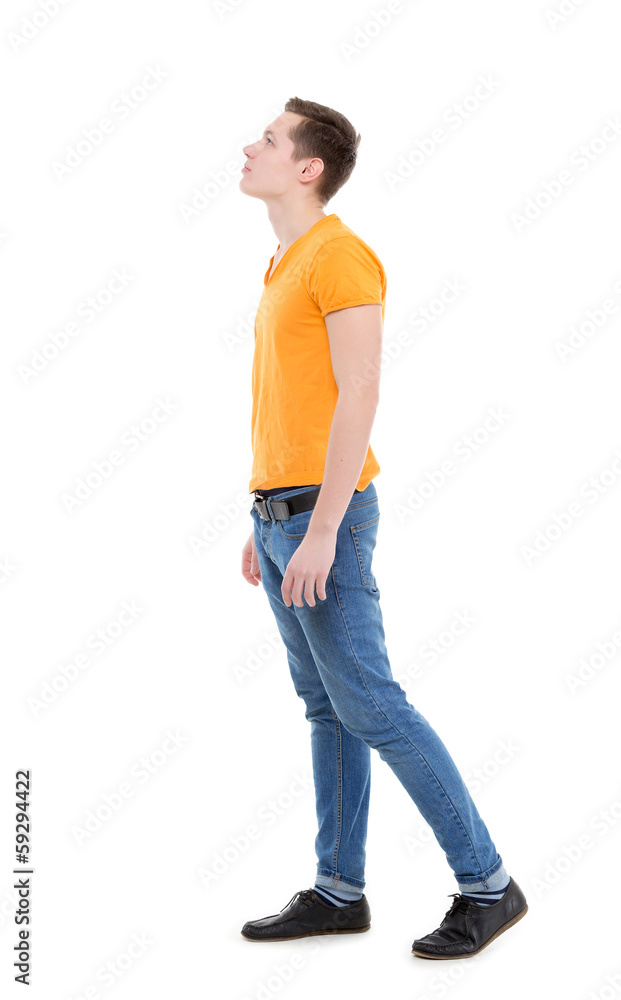 Young man wearing a yellow T-shirt and slim jeans Young man wearing a yellow T-shirt and slim jeans