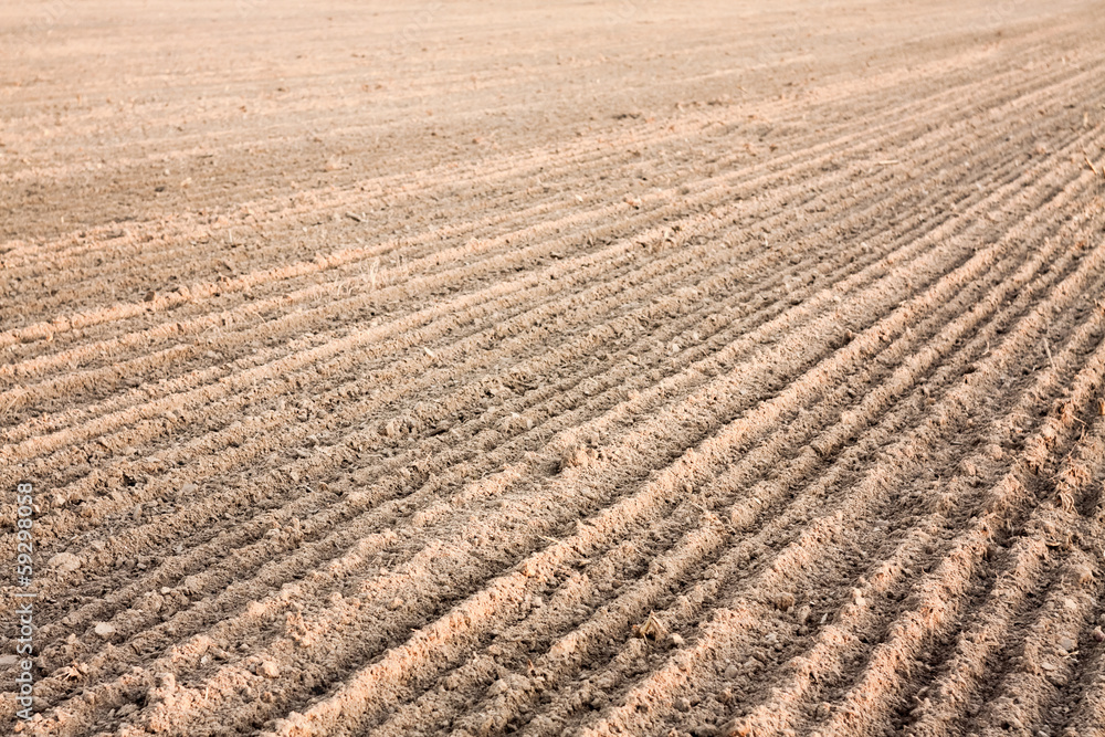 Furrows in a field after plowing it. Furrows in a field after plowing it.