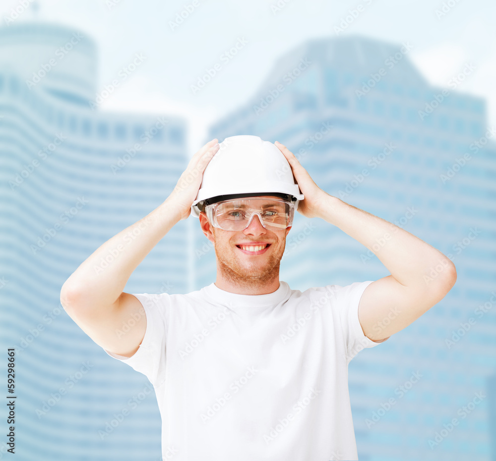 Naklejka premium male architect in helmet with safety glasses