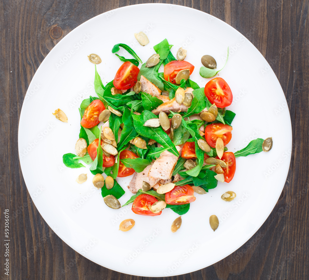 Salad with arugula, salmon and cherry tomato Salad with arugula, salmon and cherry tomato
