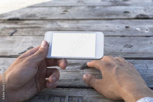 Hand holding Smartphones with Blank Screen