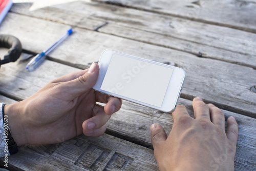 Hand holding Smartphones with Blank Screen