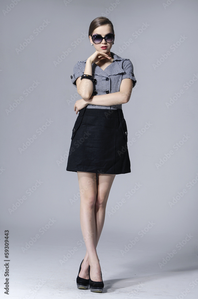 full length fashion girl in sunglasses posing gray background full length fashion girl in sunglasses posing gray background