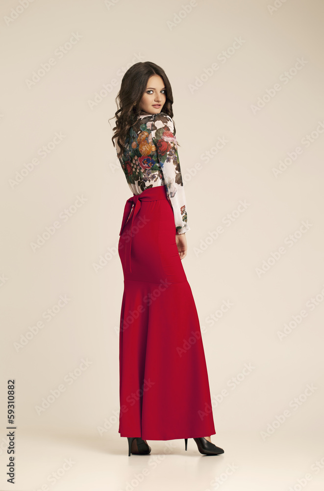 Fashion photo of young woman in red dress. Fashion photo of young woman in red dress.