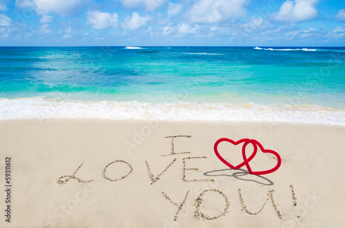 Sign "I love you" on the sandy beach