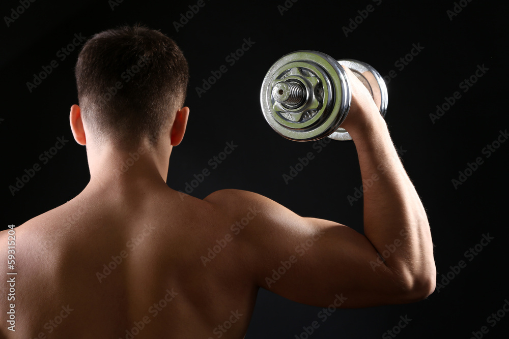 Handsome young muscular sportsman execute exercise with Handsome young muscular sportsman execute exercise with