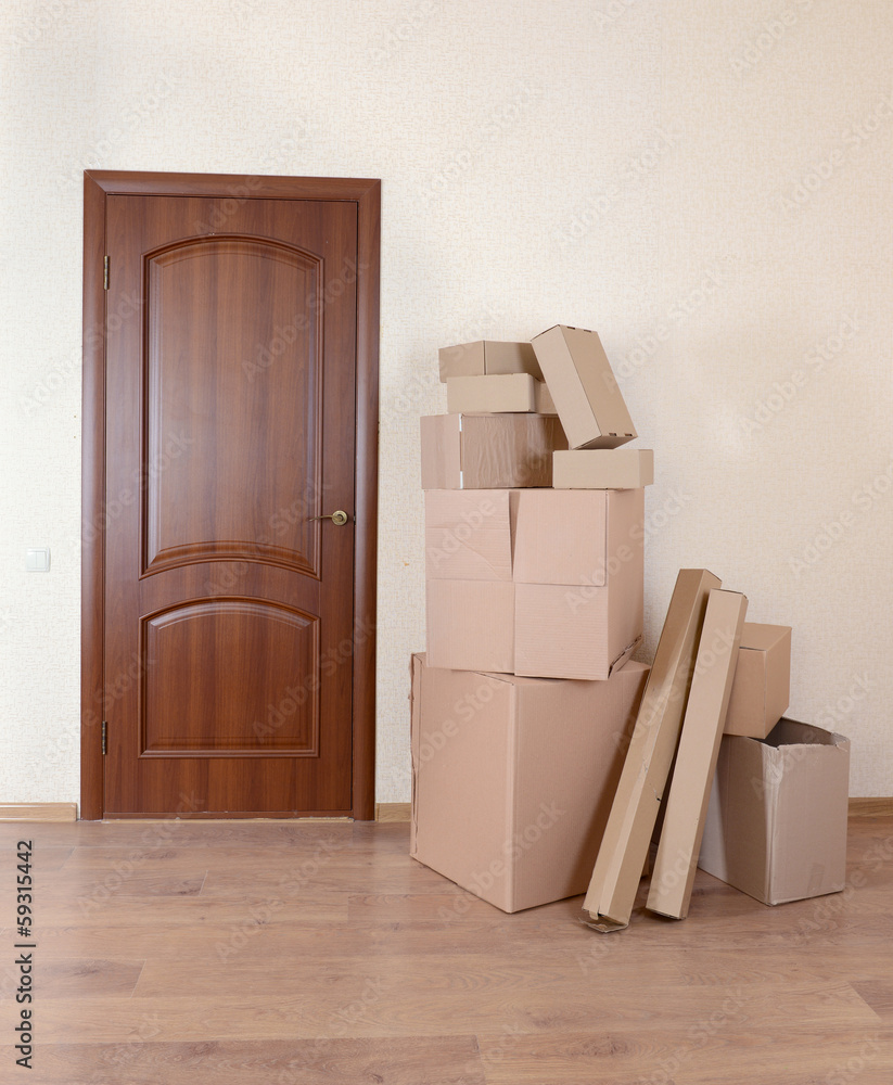 Empty room with stack of cartons: moving house concept Empty room with stack of cartons: moving house concept