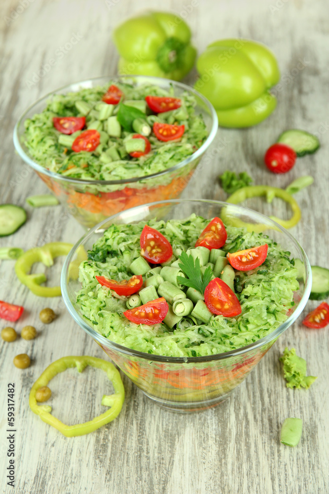 Tasty salad with fresh vegetables on wooden table Tasty salad with fresh vegetables on wooden table