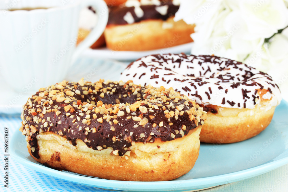 Sweet donuts with cup of tea on table close-up Sweet donuts with cup of tea on table close-up