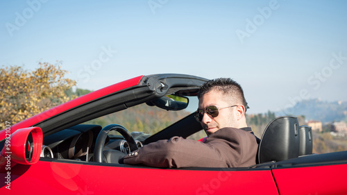 Young elegant man portrait with sport cabriolet car.