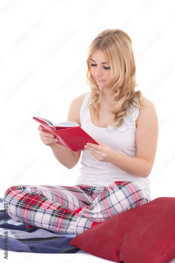pretty teenage girl in pajamas sitting and reading book isolated pretty teenage girl in pajamas sitting and reading book isolated