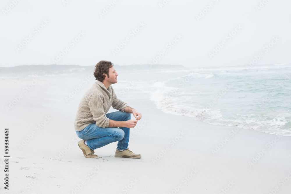 Side view of a casual young man relaxing at beach