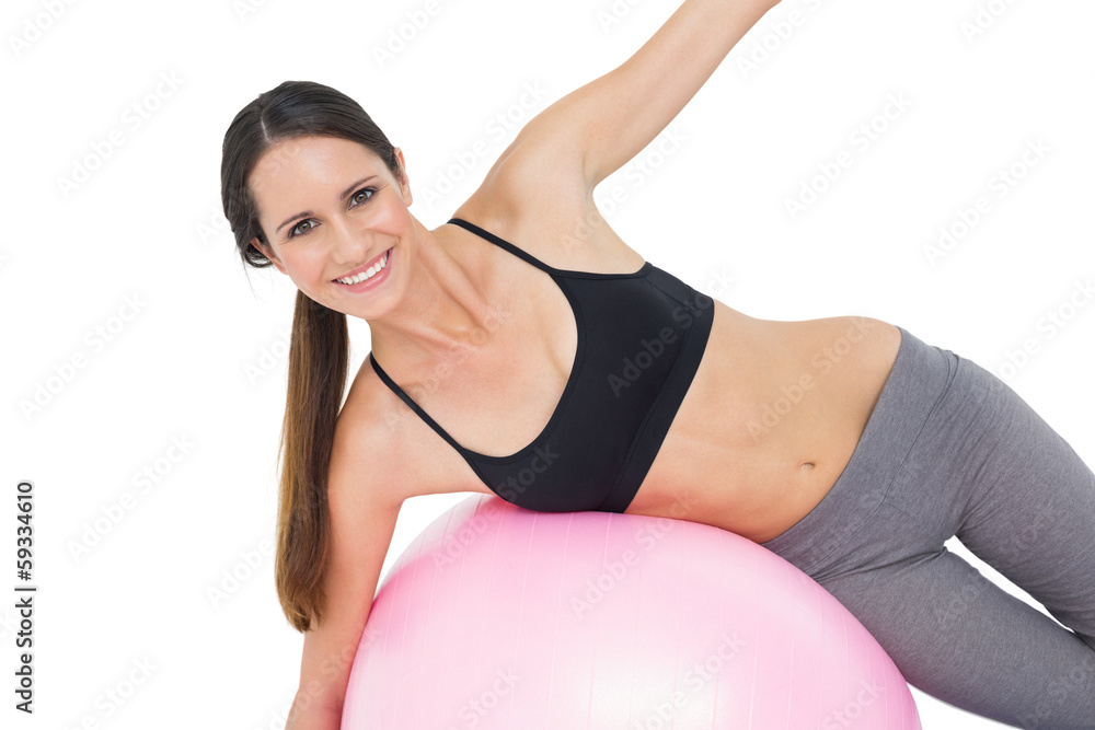 Portrait of a fit woman stretching on fitness ball Portrait of a fit woman stretching on fitness ball
