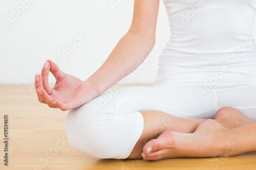 Close-up of woman in lotus pose at fitness studio