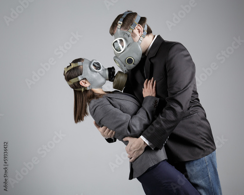 Couple in love in gas masks