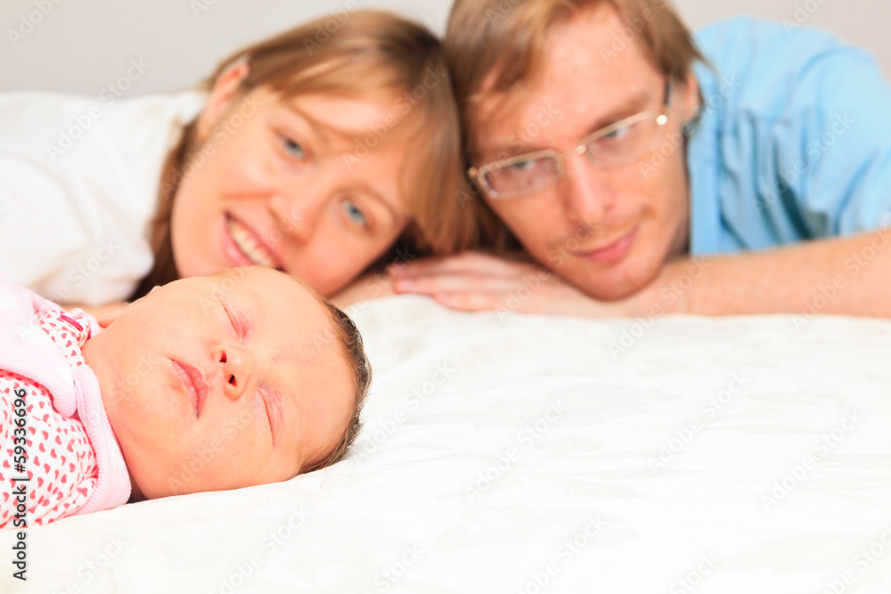 happy family enjoying time with newborn daughter happy family enjoying time with newborn daughter