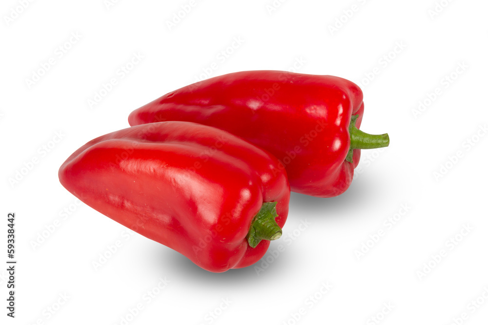 Two fresh red peppers  on white