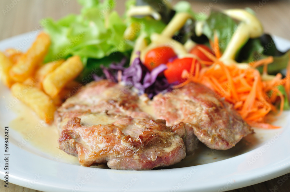 Pork steak with mix vegetables and french fried potatoes Pork steak with mix vegetables and french fried potatoes