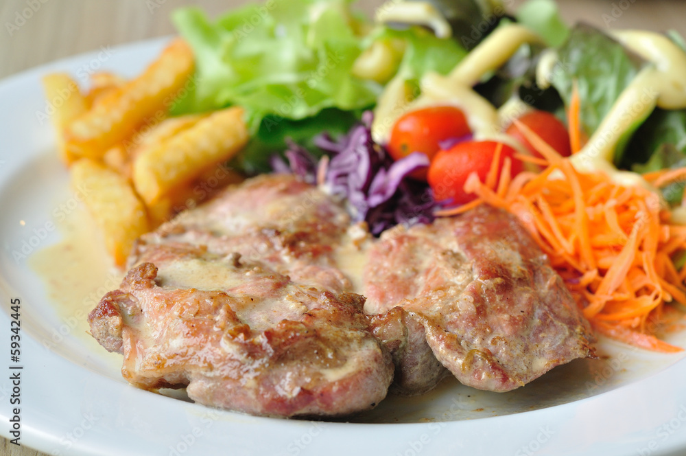 Pork steak with mix vegetables and french fried potatoes