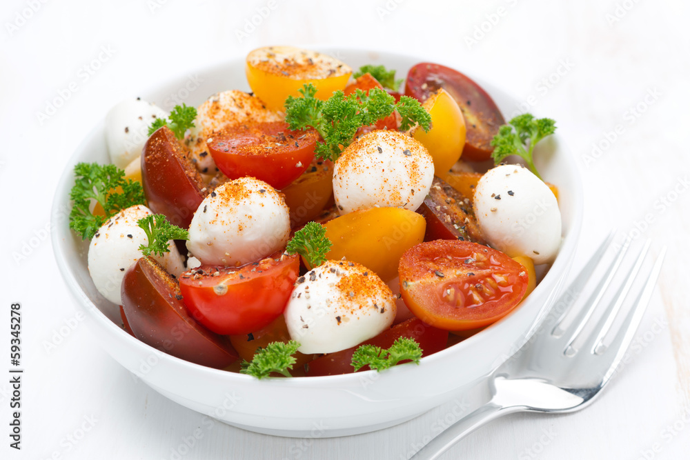 salad with mozzarella and colorful cherry tomatoes, close-up salad with mozzarella and colorful cherry tomatoes, close-up