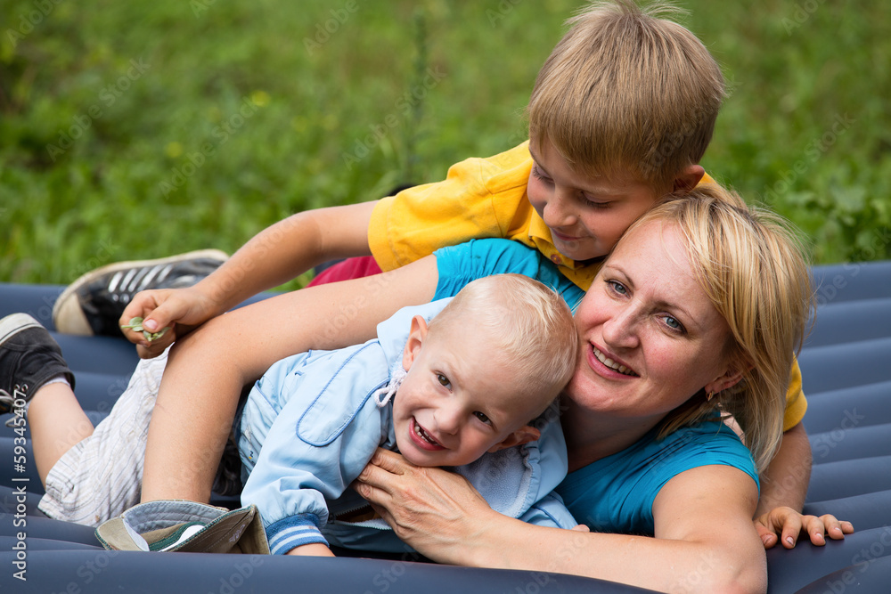 Happy mother and two sons in the park Happy mother and two sons in the park