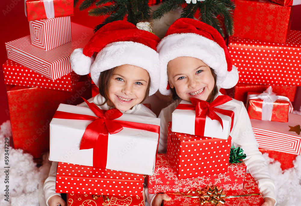 happy teen sisters decorating Christmas tree happy teen sisters decorating Christmas tree