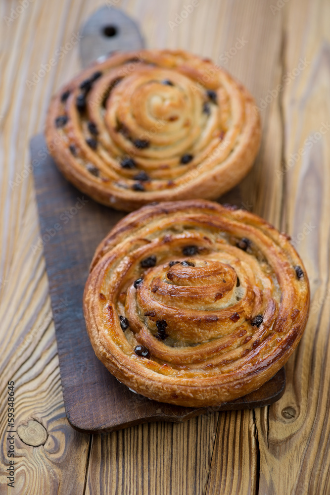 Fototapeta premium Freshly made crispy sweet roll buns, vertical shot