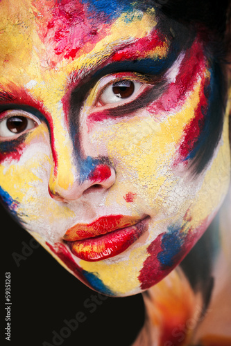 beautiful young girl with paint on his face
