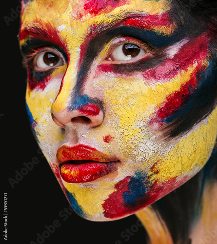 beautiful young girl with paint on his face