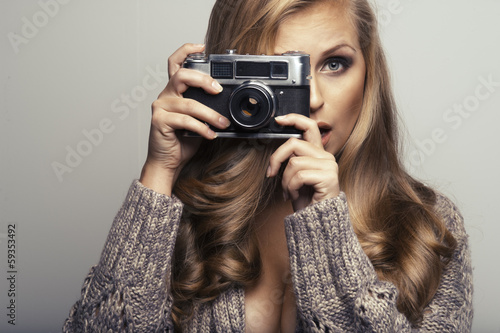 Smiling woman with camera