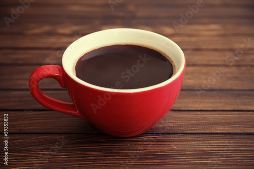 red cup coffee on wood background