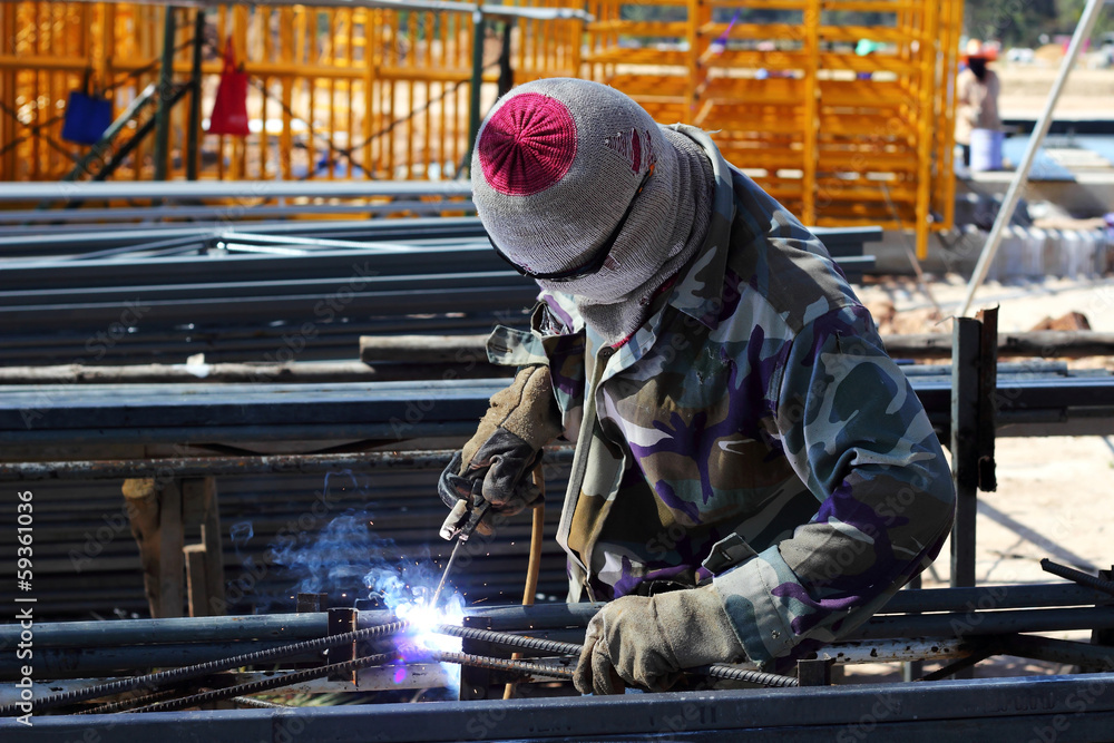welder welding steel on construction site welder welding steel on construction site