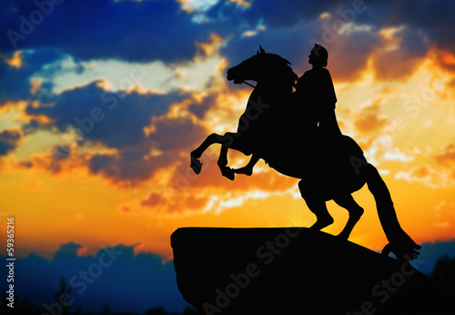 Billede på lærred Statue of Peter Great, silhouetted against the sunset. St. Peter