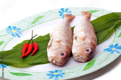 Fresh fishes on plate photo