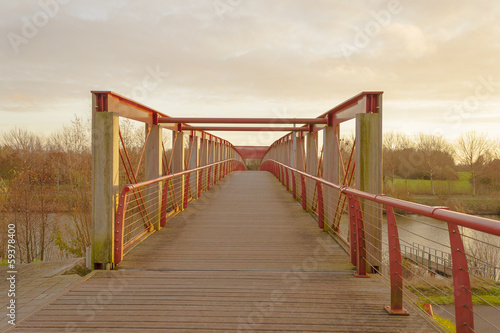Canvas Print Bridge footbridge over river in flanders belgium