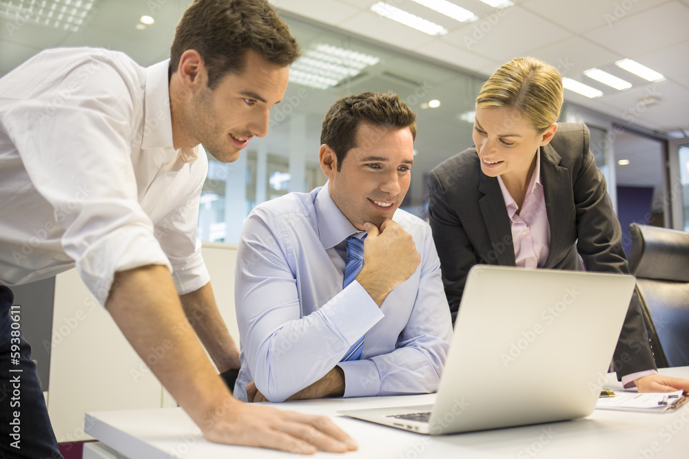 A business team of three in office and planning work A business team of three in office and planning work