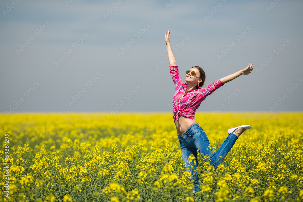 Young beautiful woman in flowering field in summer. Outdoors Young beautiful woman in flowering field in summer. Outdoors