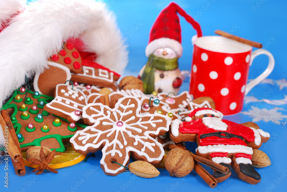 milk and assortment of gingerbread cookies for santa