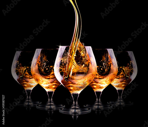 Cognac or brandy on a black photo
