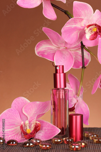 Fototapeta Naklejka Na Ścianę i Meble -  Women's perfume in beautiful bottle with orchids