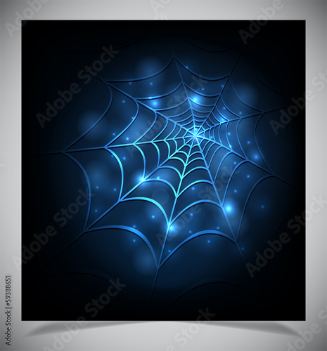Glowing spider web on a dark background