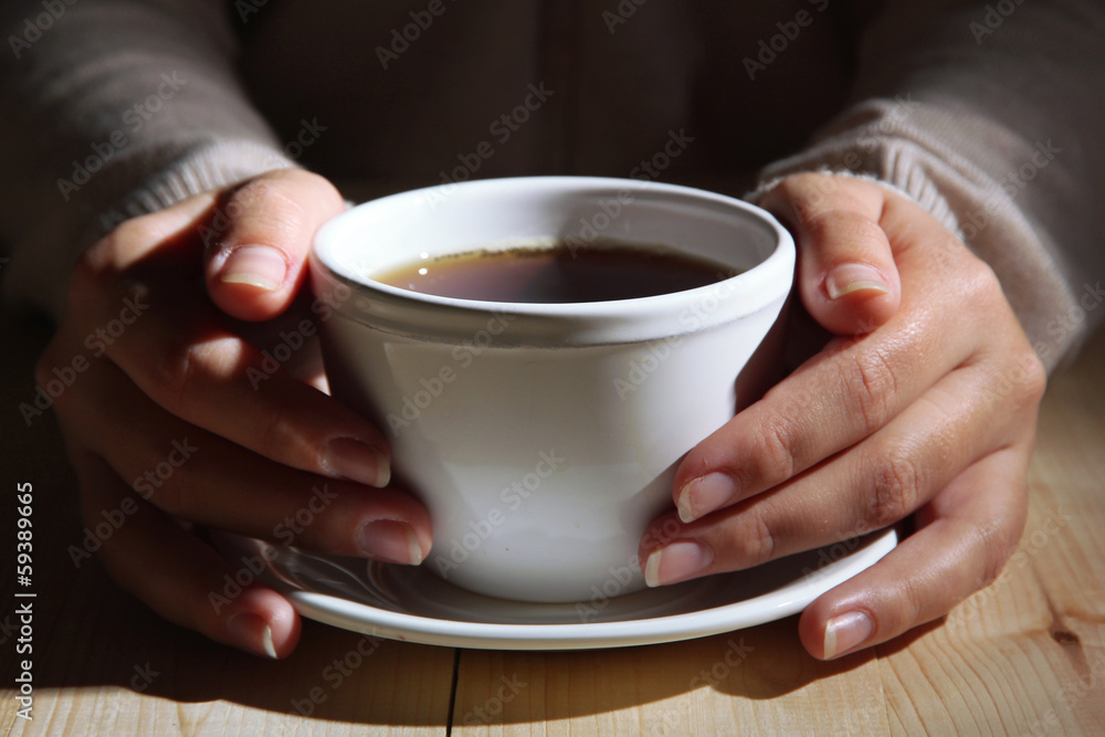 Hands holding mug of hot drink, close-up Hands holding mug of hot drink, close-up