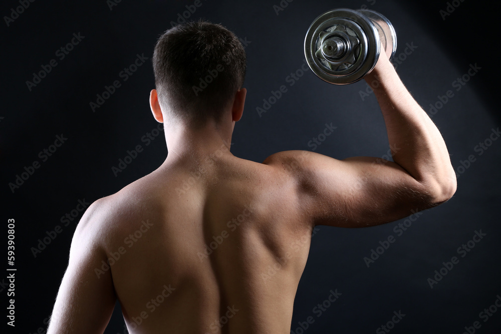 Handsome young muscular sportsman execute exercise with Handsome young muscular sportsman execute exercise with